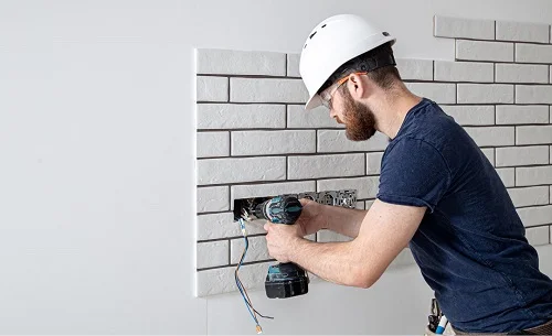 residential electrician in Los Angeles County CA installing electrical sockets